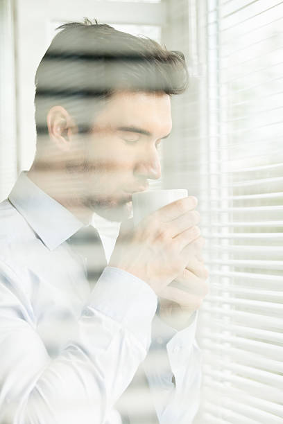 istock Businessman drinking coffee by the window 465465022