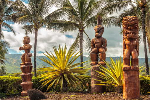 Three wooden Polynesian tiki carvings on Oahu, Hawaii