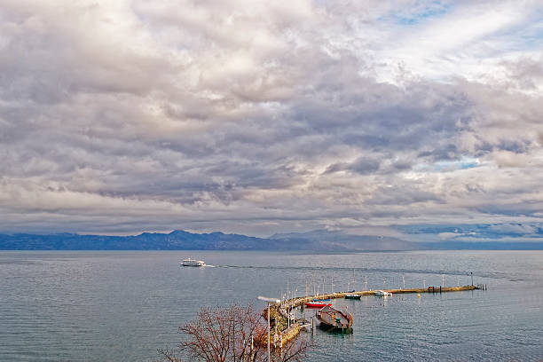 Lake view over Lac Leman in  Evian-les-Bains in France Lake view over Lac Leman in  Evian-les-Bains in France in winter evian les bains stock pictures, royalty-free photos & images