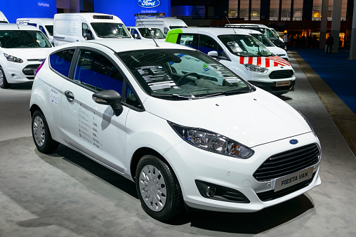 Brussels, Belgium - January 15, 2015: Ford Fiesta Van commercial vehicle on display during the 2015 Brussels motor show. People in the background are looking at the cars.