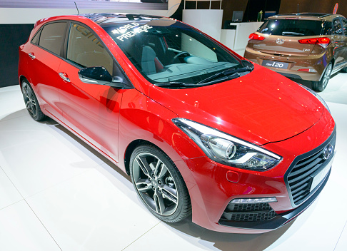 Brussels, Belgium - January 15, 2015: Hyundai I30 compact hatchback car on display during the 2015 Brussels motor show. People in the background are looking at the cars.