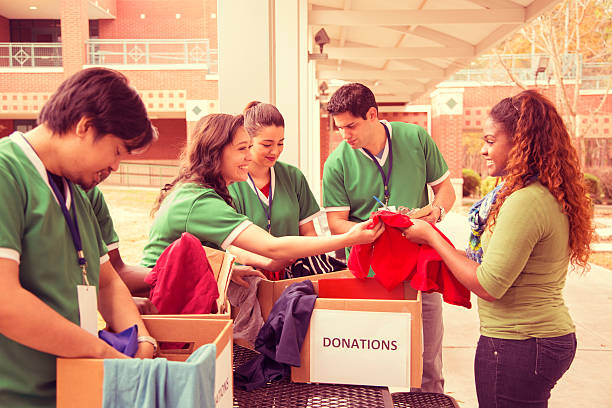 istock Volunteers: College students collect clothing donations for community. 465466851