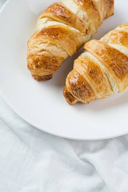 istock delicious breakfast with croissants in bed 465470866