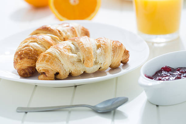 istock delicious breakfast with croissants and juice 465470872