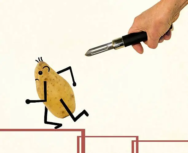 Potato running away under the threat of a vegetable peeler