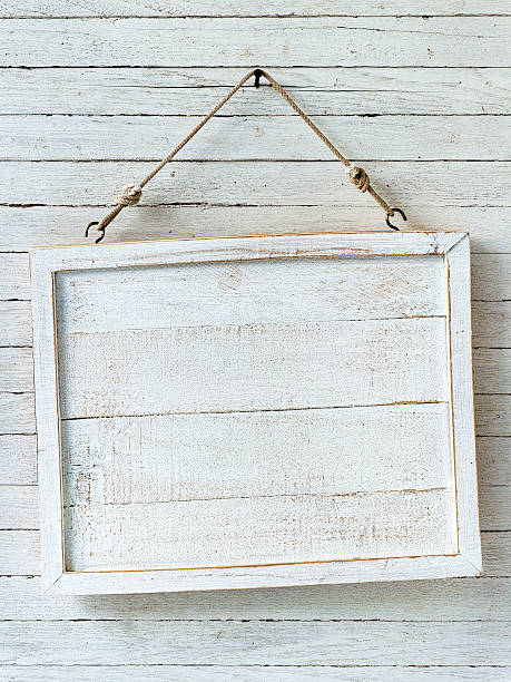 istock Old weathered white wood signboard hanging from an old nail. 465472092