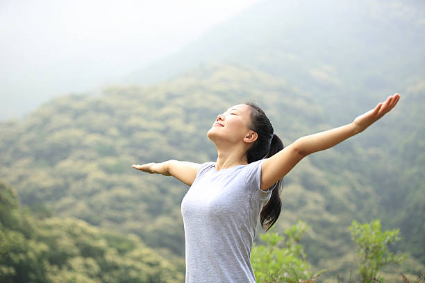 istock cheering hiking woman open arms at mountain peak 465472288