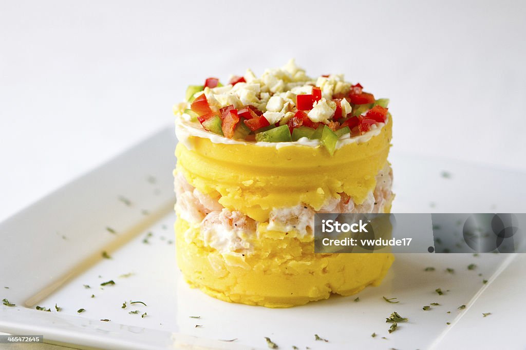 Peruvian Dish - Shrimp Causa Peruvian Cuisine Dish called Causa made with yellow potatoes and shrimp, topped with red and green peppers and egg. Peru Stock Photo