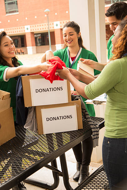 istock Volunteers: College students collect clothing donations for community. 465477123