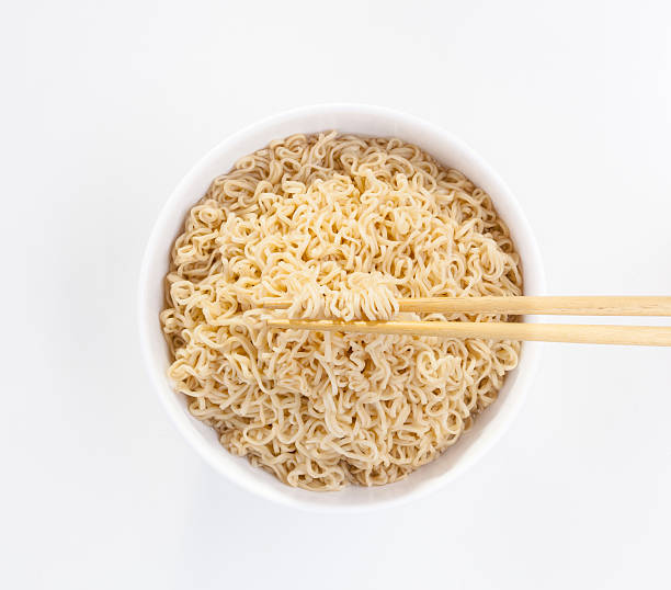 istock Instant noodle in a bowl with chopsticks isolated 465477836