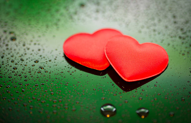 istock Two Red Hearts on wet background 465479377