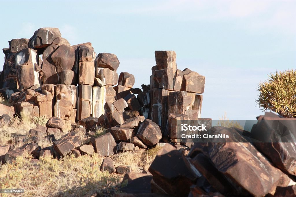 Rock formations in Namibia under blue sky Rock formations in Namibia, africa, africa, aloe, aloen, ast, branches, tree, blue, trees, bushmen, three, rock, rock, yellow, grass, sky, keetmanshoop, quiver, quiver tree, quiver trees, landscape, namibia, namiba, nature conservation, arrows, plant mark, stone, stones, san, settlement weaver, sunset, succulent, quivertree, bark, wild, wilderness, clouds, yellow 2015 Stock Photo