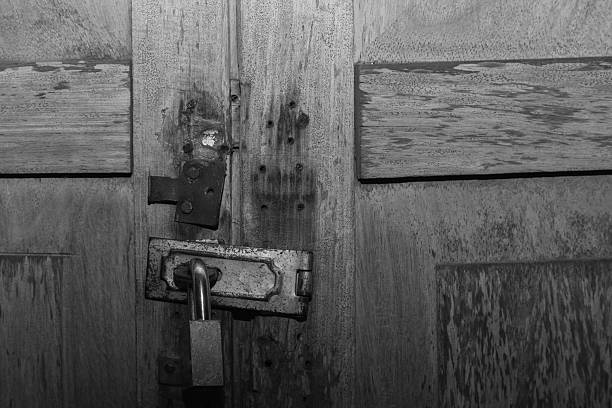 istock old wooden door locked with padlock 465480790