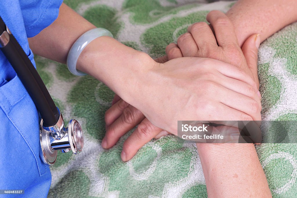 Doctor holding patient's hand A Helping Hand Stock Photo