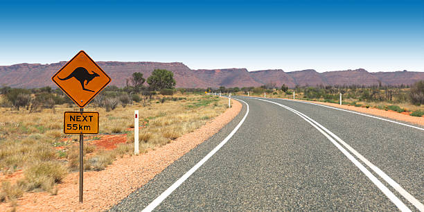 Kangaroo Sign on the Road to Kings Canyon Australia Kangaroo warning sign on the road to KingsCanyon, Northern Territory, Australia kangaroo crossing sign stock pictures, royalty-free photos & images