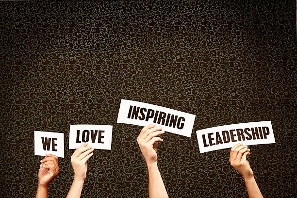 istock 'We love inspiring leadership' say hand-held signs 465484667