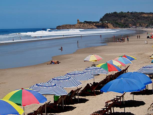Crowds enjoy the beach and the water,Montañita, Ecuador Montañita, Ecuador - March 3, 2015: Crowds enjoy the beach on a sunny day in Montañita, Ecuador montanita ecuador stock pictures, royalty-free photos & images