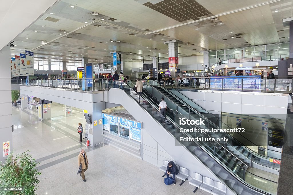 Passengers  at escalator and hall at Belgrade airport Nikola Tesla Belgrade, Serbia - February 18, 2014: Passengers  at escalator and hall at Belgrade airport Nikola Tesla, the fastest growing major airport in Europe. 2015 Stock Photo