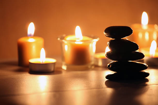 istock Balancing zen stones and pebbles with candles on wooden table 465486097