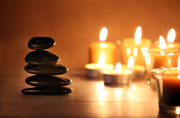 istock Balancing zen stones and pebbles with candles on wooden table 465486149