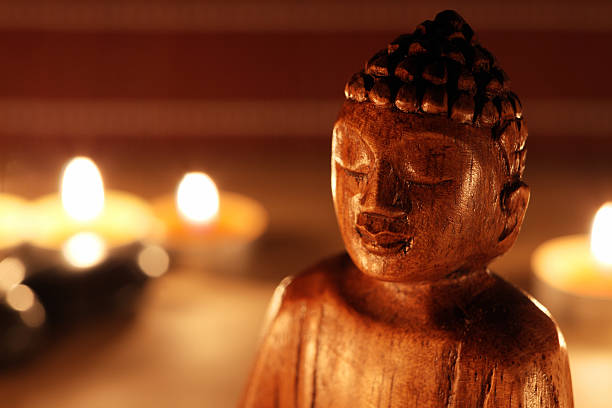 istock Close-up of Buddha statue with candles 465486161