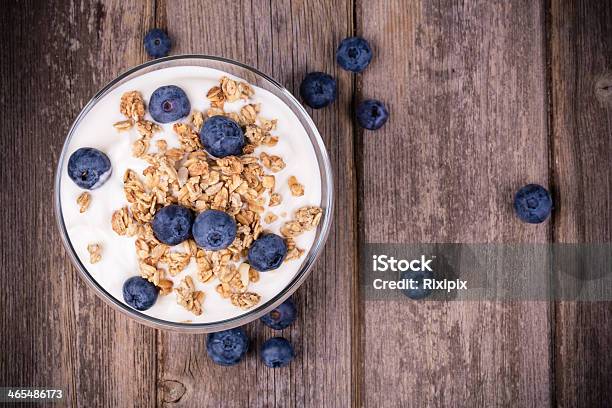 Cup Of Yogurt With Granola And Blueberries Stock Photo - Download Image Now - Yogurt, Blueberry, Bowl