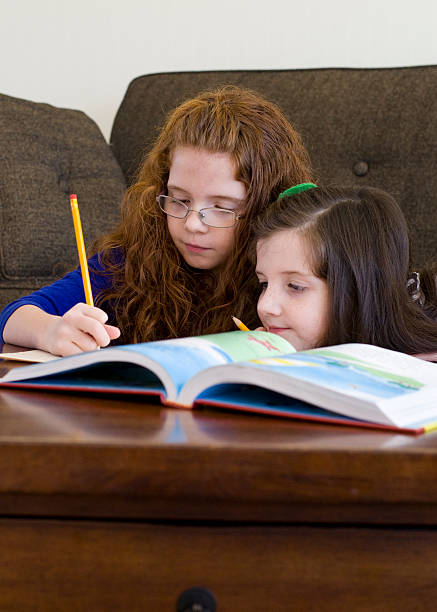 istock girls do school work together 465486301