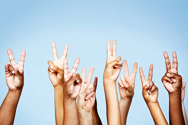 istock Many mixed hands make Peace hand sign against blue 465486661