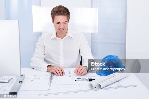 Young Architect Drawing Plan On Blueprint Stock Photo - Download Image Now - Adult, Adults Only, Architect