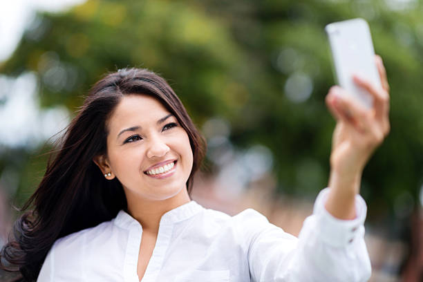 istock Woman taking a selfie at the park 465487777