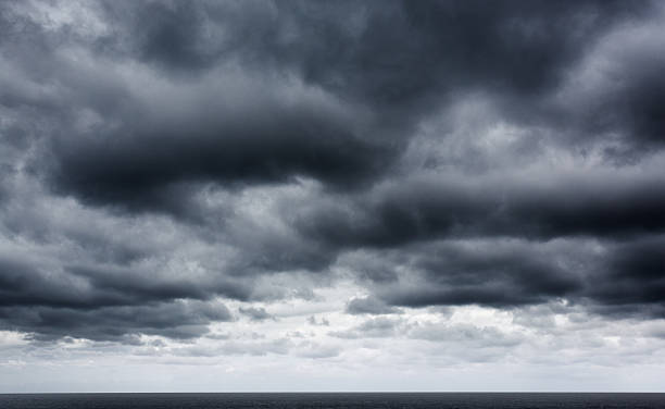 istock Moody monochrome view of storm clouds advancing over ocean 465488329