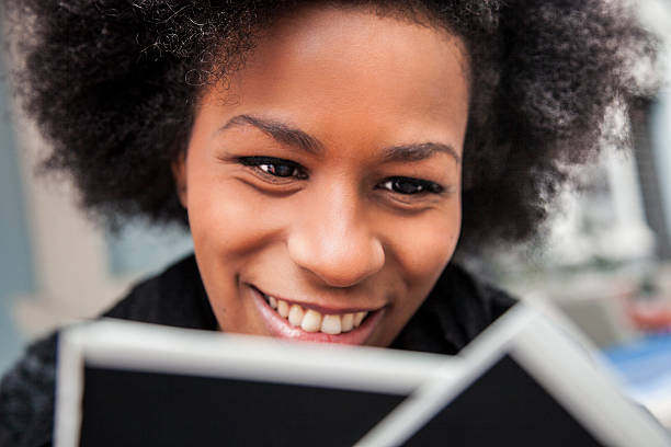 istock Young woman browses instant camera photo frames 465488838