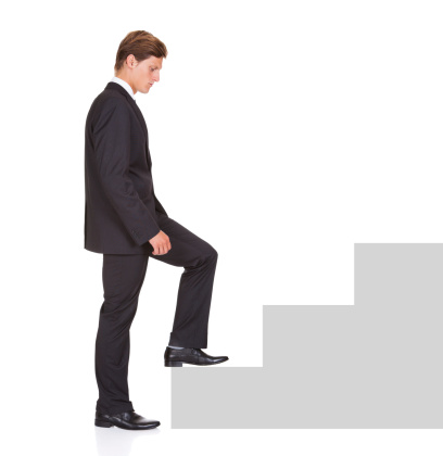 Young Businessman Started Climbing Step Of Success On White Background