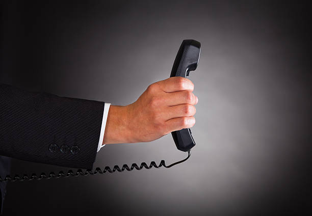 istock Hand Holding Telephone Receiver Over Black Background 465490727
