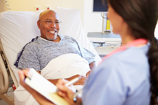 istock Close Up Of Nurse Updating Patient Notes 465490871