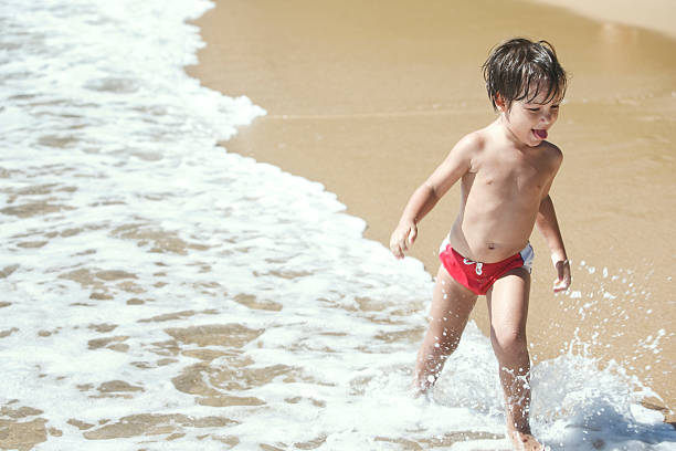 istock Four- year-old boy running on the beach. 465492300
