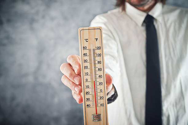 istock Businessman holding thermometer with temperature on Zero value 465492969
