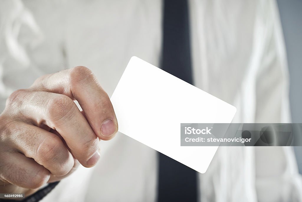 Businessman holding blank credit card Businessman paying with credit card, selective focus. Blank credit card with copy space for any title or design. Adult Stock Photo