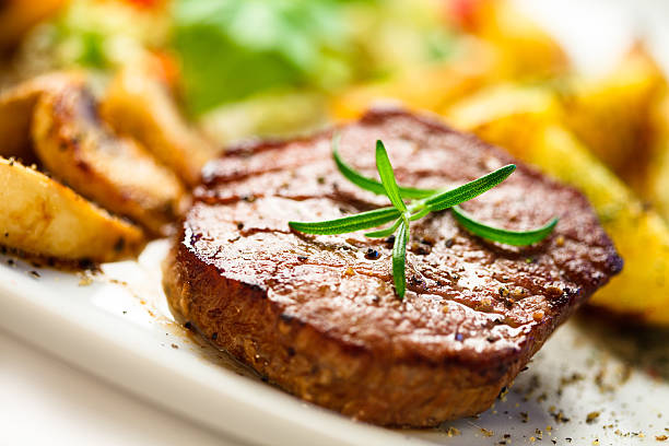 istock Grilled steak, baked potatoes and vegetables on white background 465493368