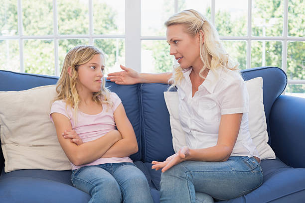 istock Woman explaining little girl on sofa 465493448