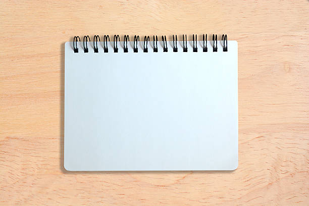 istock white page of notebook on wood texture 465493882