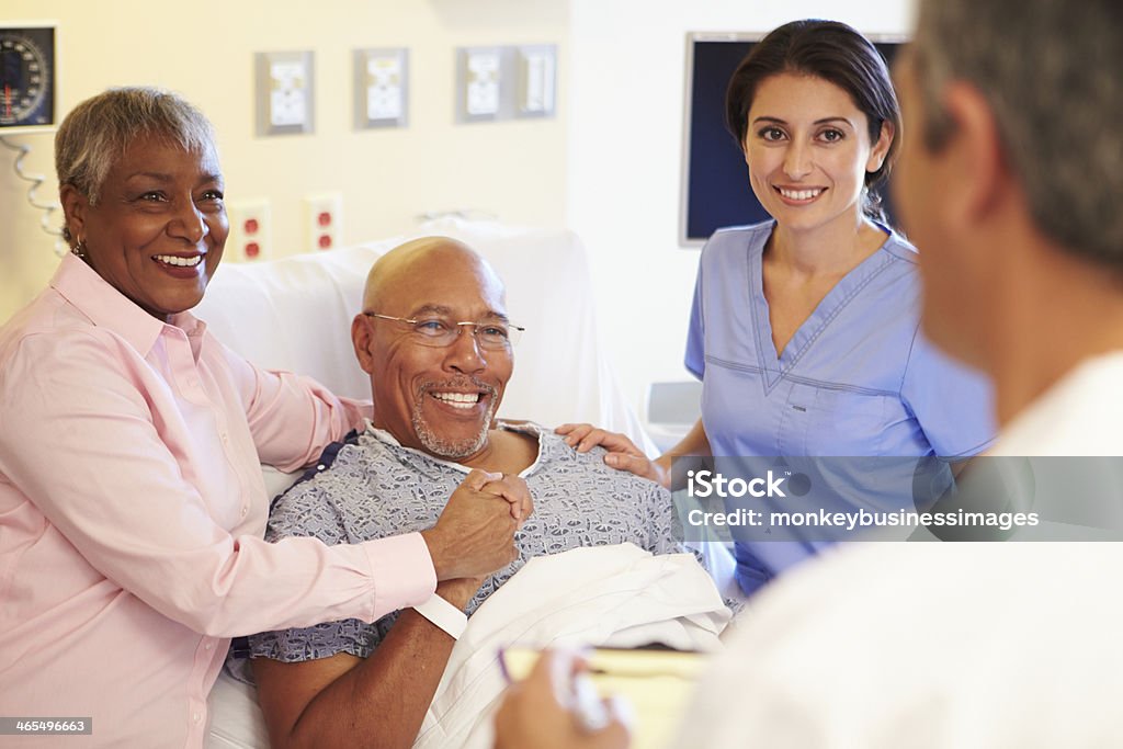 Medical Team Meeting With Senior Couple In Hospital Room Medical Team Meeting With Happy Smiling Senior Couple In Hospital Room Patient Stock Photo