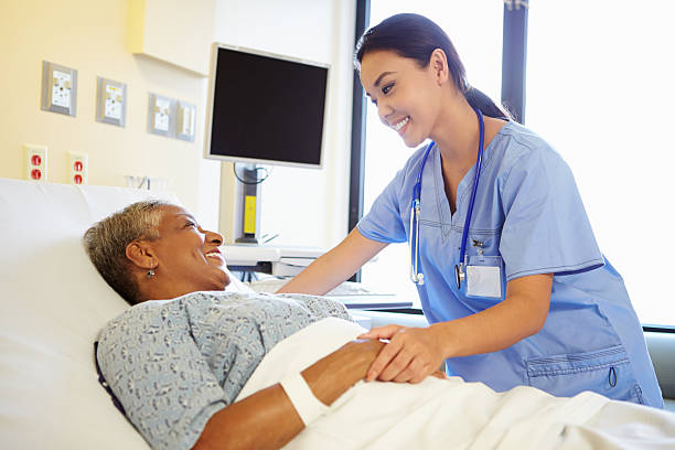 enfermera hablando con mujer senior en hospital habitación - patient female hospital recovery fotografías e imágenes de stock