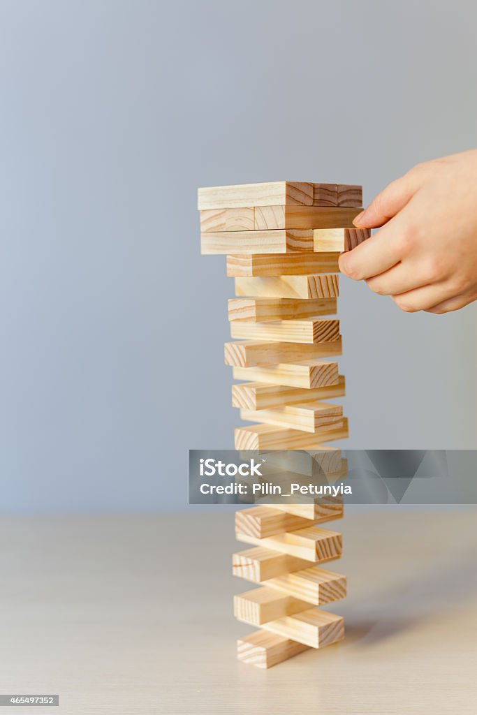 wooden blocks game wooden blocks game with human hand 2015 Stock Photo