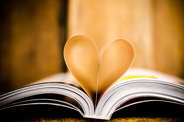 istock Heart from book pages on wood background 465497592