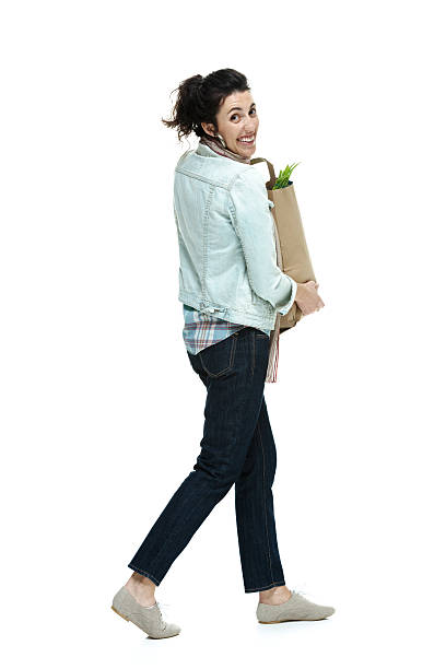 istock Happy young woman walking 465497603