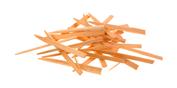 A jumble of wood plaque removing toothpicks on a white background.