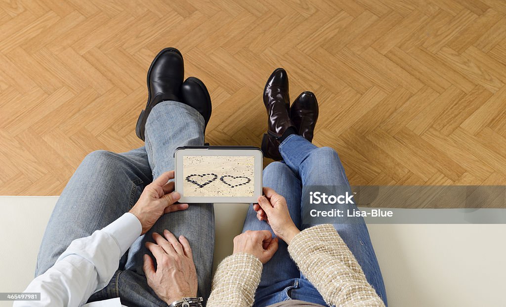Mature Couple Looking Valentine's Day on Tablet looking valentine's photo on tablet. Above Stock Photo
