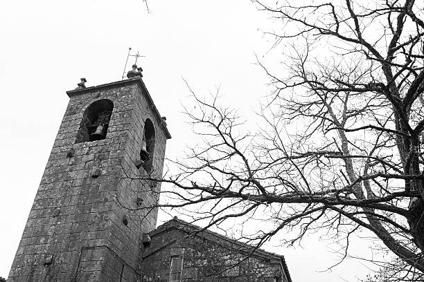 Black and white low angle view of the romanesque church of San Estevo (Esteban) in Allariz, Ourense, Spain.