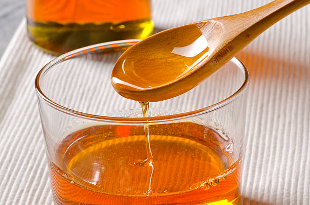 istock Agave syrup pouring on a glass. 465501314